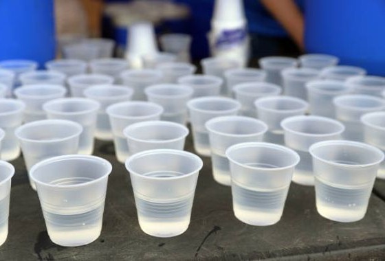 Runner drinking water post-run to replace fluids