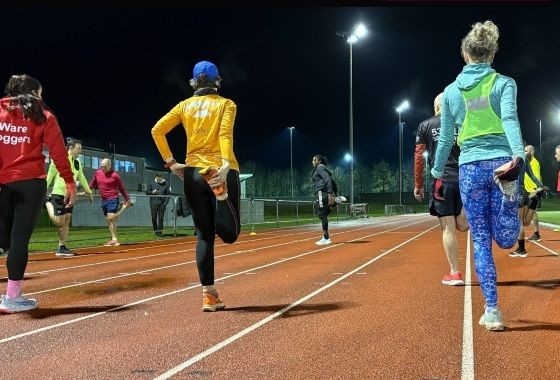 Runner holding a calf or quad static stretch post-run